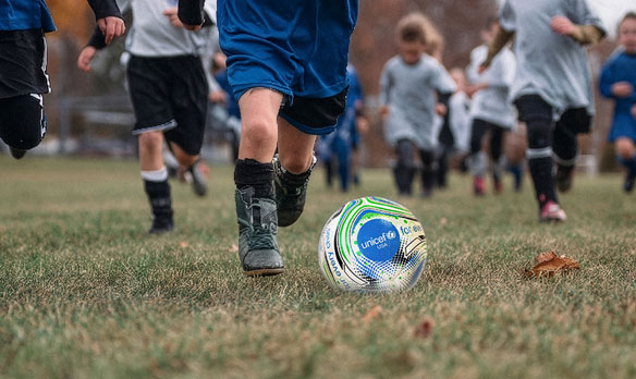 Children playing with a Unicef soccerball